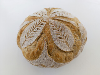 Handmade sourdough bread with symmetrical drawing