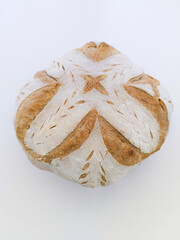 Handmade sourdough bread with symmetrical drawing.