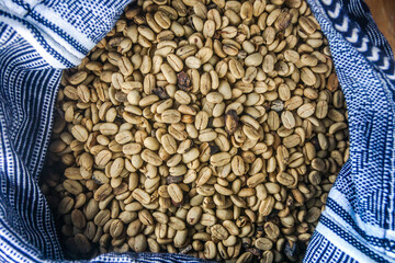 A blue sack full of yellow coffee seeds