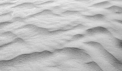 Naklejka na ściany i meble grey sand shaped into waves by the wind