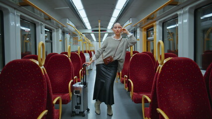 Beautiful passenger posing train leaning at handrail zoom in. Short hair model