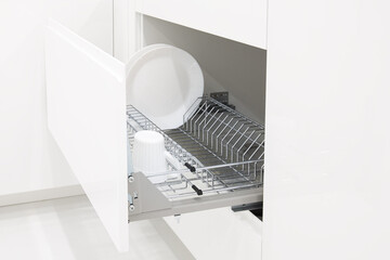 Open kitchen drawer with metal dish dry rack