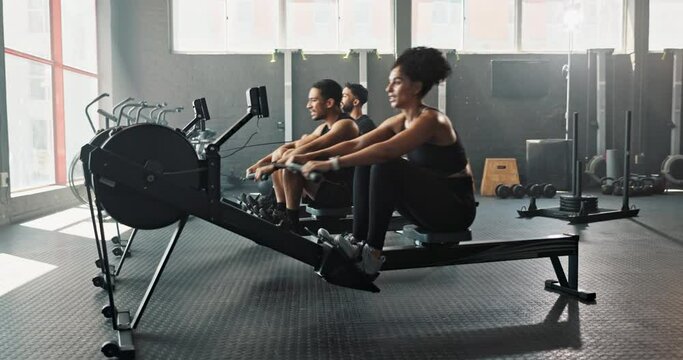 People, rowing machine and gym workout for exercise challenge or fitness teamwork, friends or cardio. Men, woman and healthy training at sports centre together or athlete goals, wellness or endurance