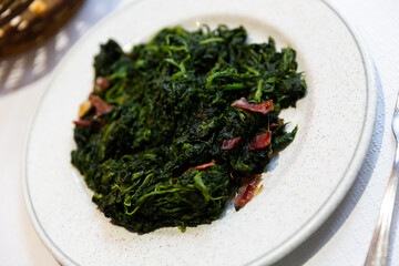 Catalan Spinach served on table with serving pieces