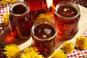 Several jars of dandelion honey - syrup made of fresh dandelion flowers in spring