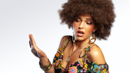 Disgust ethnic retro girl with big hair and 1970s style clothing gesturing with her hand
