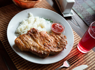 Delicious fried pork escalope with side dish of boiled white rice served with piquant plum sauce