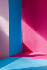 An abstract creative photo capturing the interplay of light and shadow on bold pink and blue geometric shapes creating a modern visual effect..