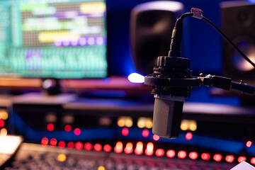 Empty control room with professional recording microphone and technical gear used for producing and...