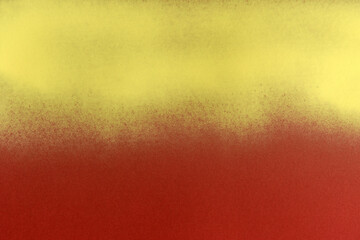 yellow spray paint on red paper background