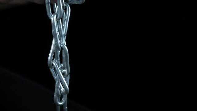 Movement against social violence indoor. A person with chain in hands want to stop the social aggression.