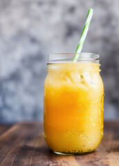 Fototapeta premium Close-up of a mason jar filled with pineapple ginger cooler. AI generated.