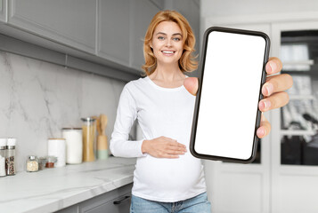 Pregnant woman showing blank smartphone screen, mockup