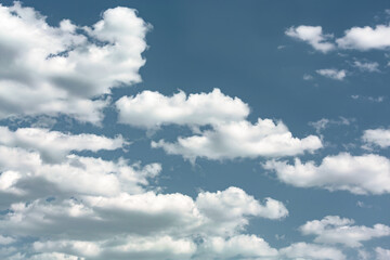 Fluffy cumulus clouds on a bright blue sky, tinted, natural atmosphere backgrounds