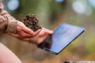 university student conducting research on forest health. farmer collecting soil samples in a test...