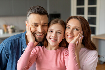 Happy family posing together in kitchen, closeup