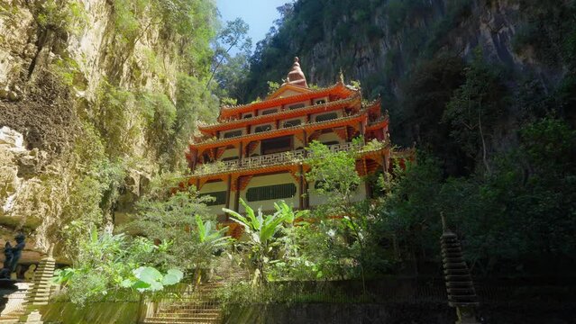 Moving towards the Sam Poh Tong Temple surrounded on all sides by steep limestone cliffs and a cave tunnel in Ipoh, Malaysia