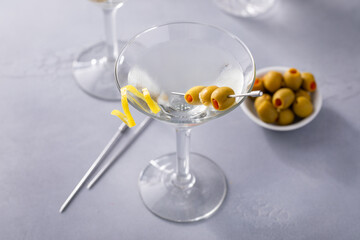 Lemon drop martini cocktail with olives and a lemon twist