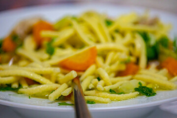 Healthy soup with chicken, vegetables and noodles.