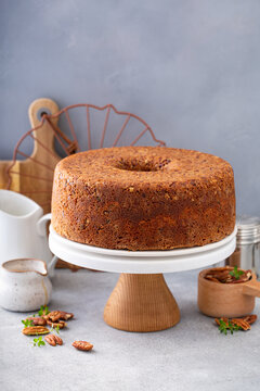Pecan caramel pound cake baked in a bundt pan served on a cake stand