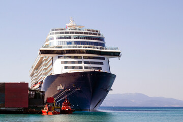 View of the front of a very large tourist cruise ship docked in the port