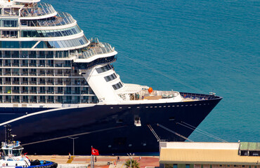 View of the front of a very large tourist cruise ship docked in the port