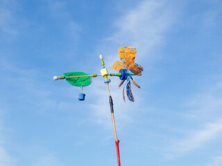 Homemade weather vane from a plastic bottle on the seashore. Wind propeller.