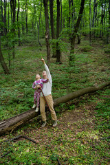Naklejka na ściany i meble Mother and little daughter enjoying time in nature together