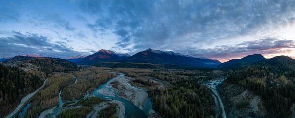 Aerial View of the River and Mountains. Dramatic Cloudy Sky.