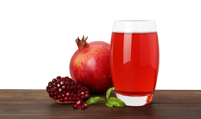 Refreshing pomegranate juice in glass, leaves and fruits on wooden table against white background