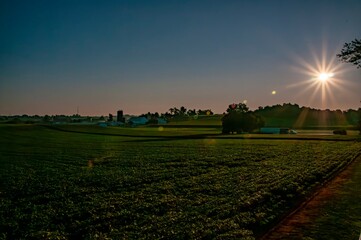 Dawn's Radiance Over Farmland
