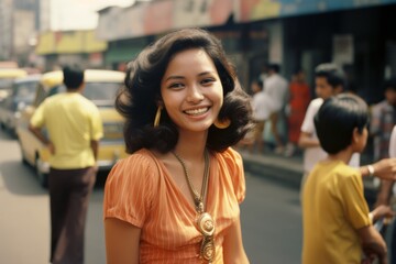 Young Filipina woman smiling happy on city street in 1970s