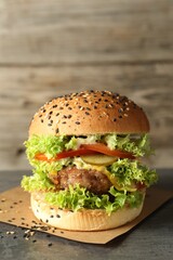 Burger with delicious patty on gray table