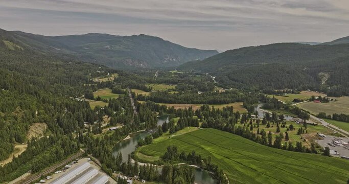 Sicamous BC Canada Aerial v3 drone flyover Eagle river capturing agricultural farmlands, golf country club, lush forests and mountainous landscape - Shot with Mavic 3 Pro Cine - July 2023