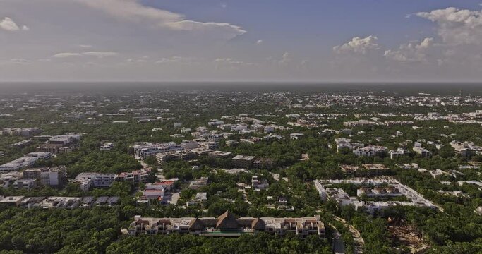 Tulum Mexico Aerial v14 panoramic panning views drone flyover luxury neighborhood capturing views of La Veleta and town center with tropical clouds on the sky - Shot with Mavic 3 Pro Cine - July 2023