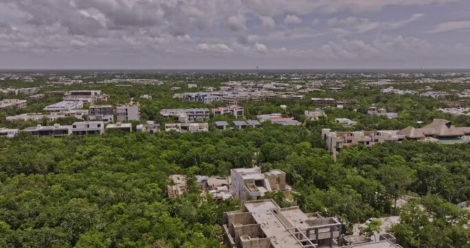 Tulum Mexico Aerial v4 drone flyover luxury neighborhood capturing views of La Veleta and town center with construction of new properties and ocean views - Shot with Mavic 3 Pro Cine - July 2023