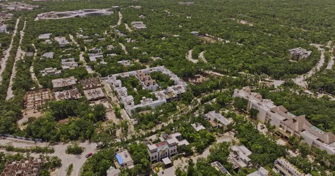 Tulum Mexico Aerial v2 birds eye view drone flyover luxury neighborhood, tilt up reveals landscape view of La Veleta and town center - Shot with Mavic 3 Pro Cine - July 2023