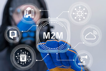 Engineer using virtual touch screen presses abbreviation: M2M. M2M Machine-to-Machine Business Industrial concept. Machine to Machine Smart factory AI technology.