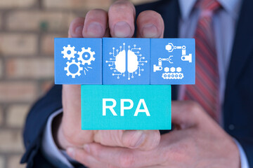 Business man holding blocks with icons sees abbreviation: RPA. RPA Robotic Process Automation innovation technology concept. Automation RPA Workflow business industrial process optimization.