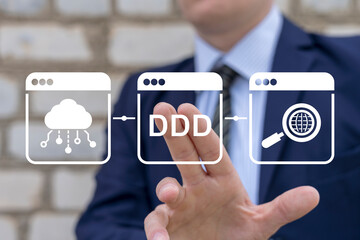 DDD Domain-Driven Design Software Development Programming concept. Young business man pressing on virtual touch screen button with abbreviation: DDD. Data driven marketing technology.