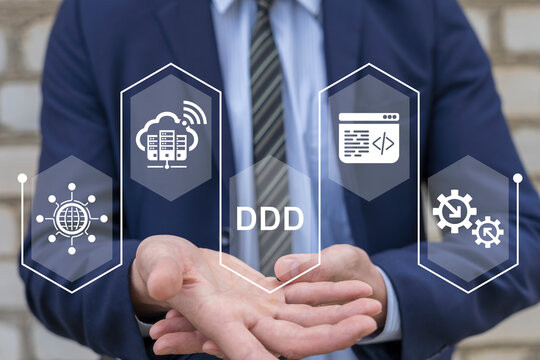 DDD Domain Driven Design Development concept. Young business man using virtual screen sees abbreviation: DDD. Data driven marketing technology.