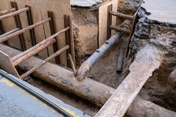 The street undergoes infrastructure maintenance, with a replacement of sewer and water systems. This urban development project involves repairing pipes and upgrading the city's infrastructure.