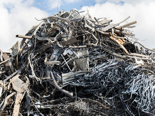 a pile of scrap metal at a recyling factory