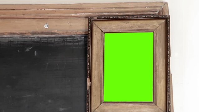 Old Wooden Frame with Green Background at School. Close Up. You can replace green screen with the footage or picture you want with “Keying” effect in After Effects (check out tutorials on YouTube). 