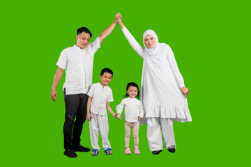 Happy Asian muslim family of four having fun together isolated