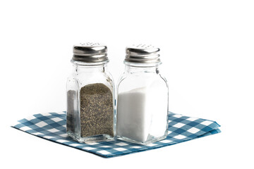 salt and pepper shakers on a blue checked restaurant paper