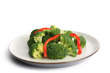 A heaping serving of broccoli with red pepper slivers on a plate isolated on white