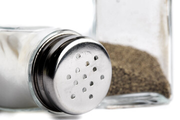 salt and pepper shakers knocked over on teh side on white