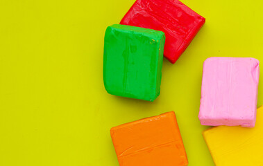 Colorful plasticine clay on pink background.