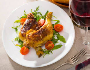 Fried chicken legs with arugula and tomatoes. High quality photo